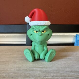 Add a little mischief to your holiday decor with this adorable Grinch figurine!